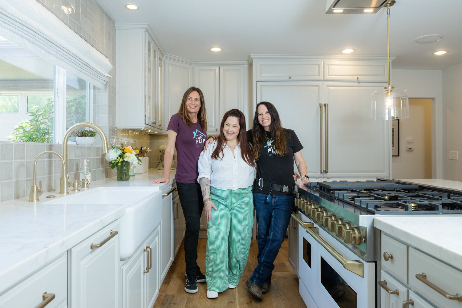 Carnie Wilson with Girl Flip Construction founders Erica and Beth in her remodeled kitchen