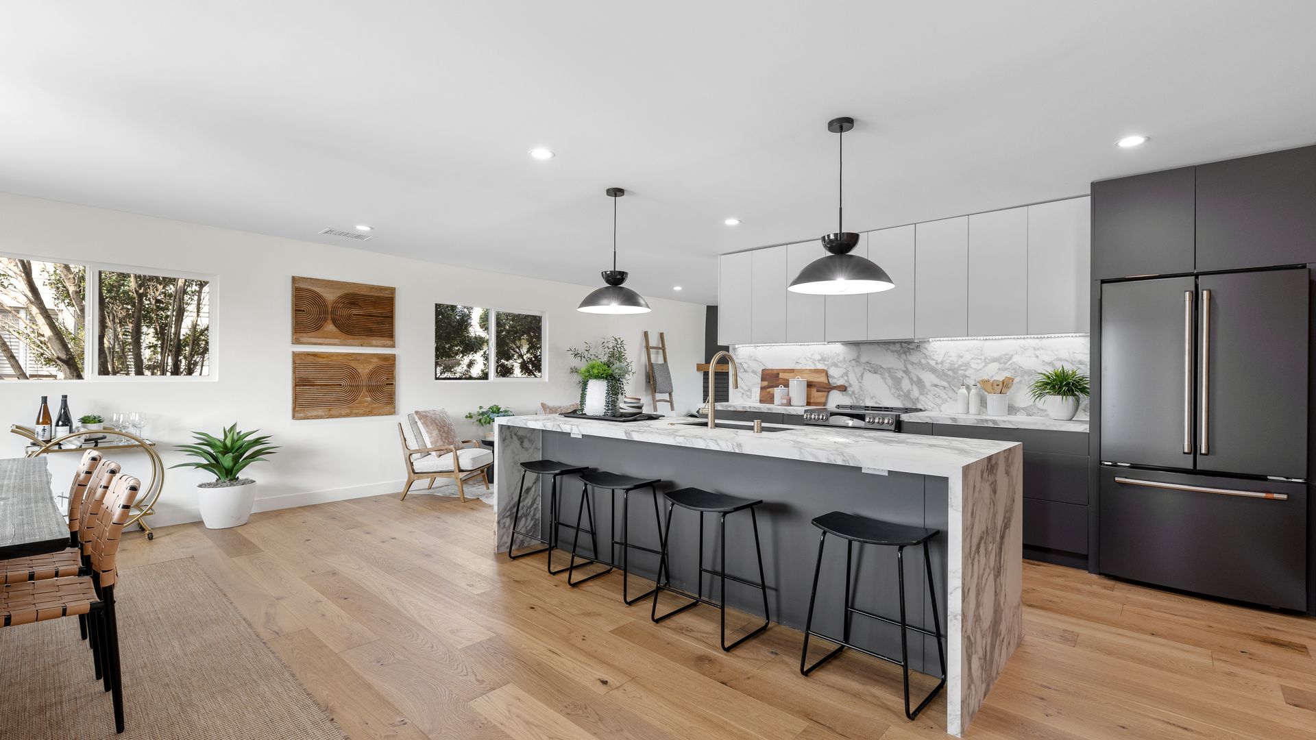 Bright modern kitchen remodel with island and barstools by Girl Flip Construction in Los Angeles