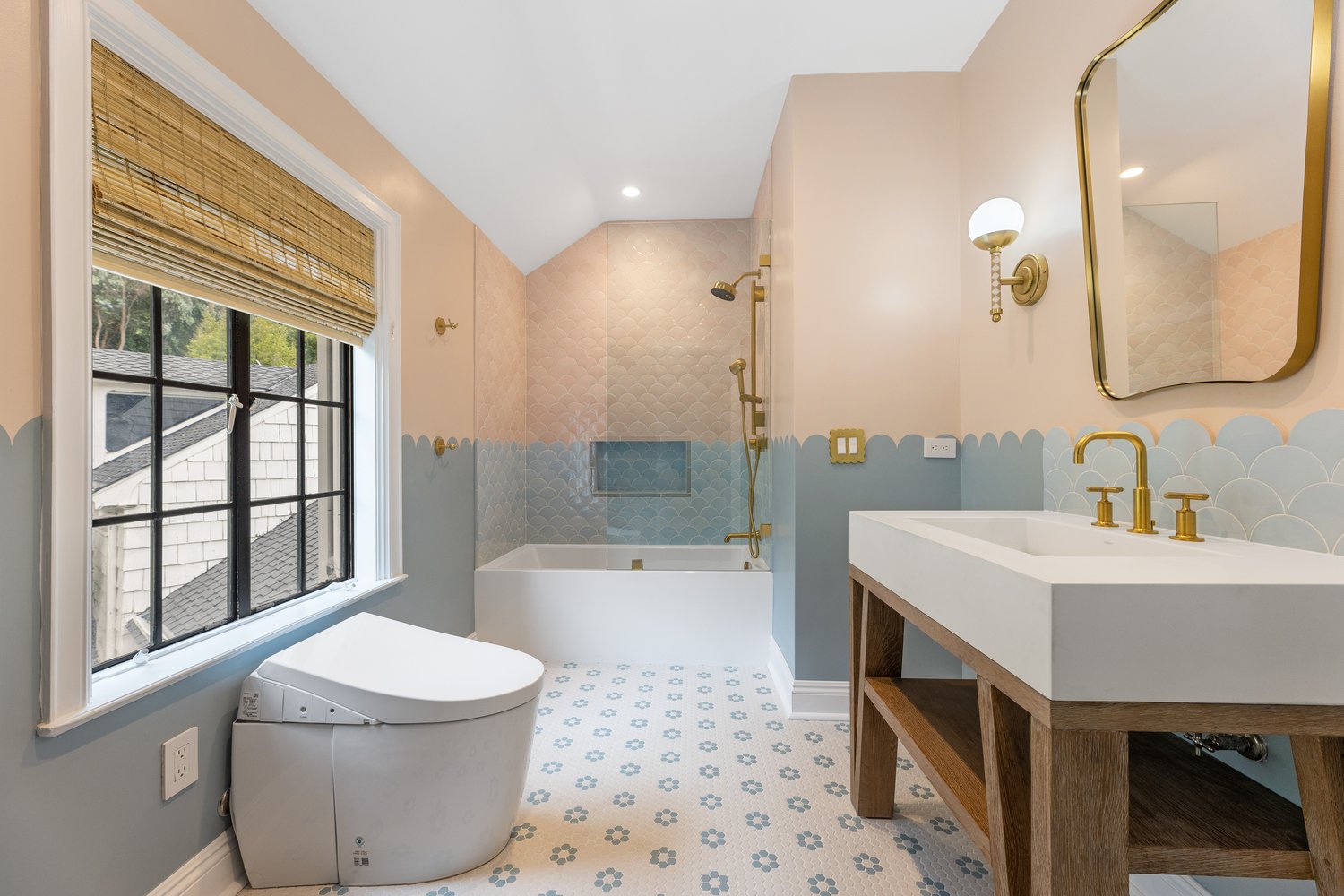 Scalloped wall tile and patterned floor tile in a bathroom