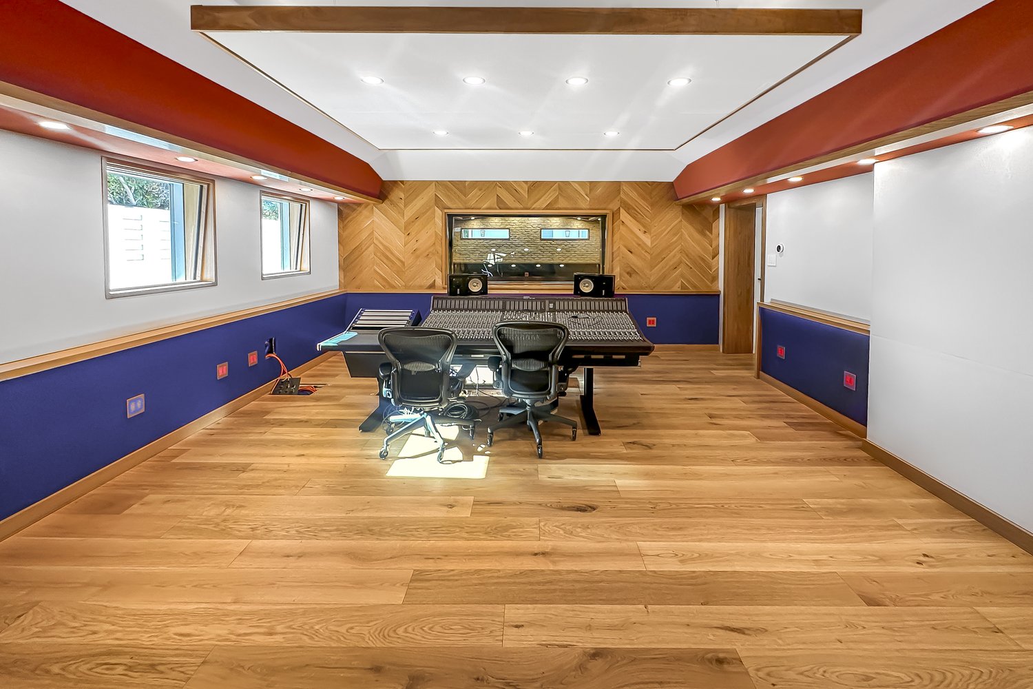 Studio room with a mixing desk and acoustic panels